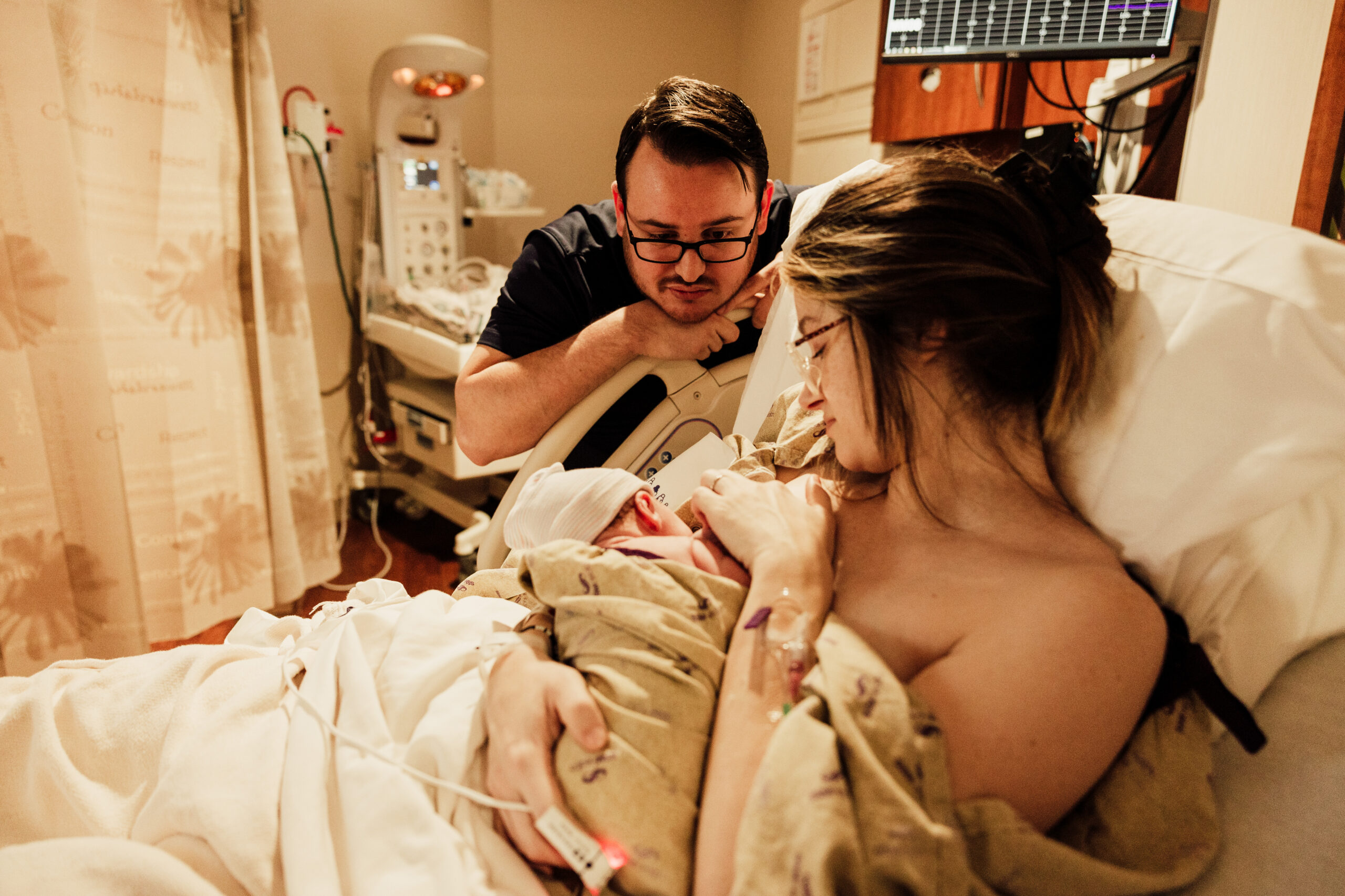 Mother holds newborn baby in hospital in St. Louis.