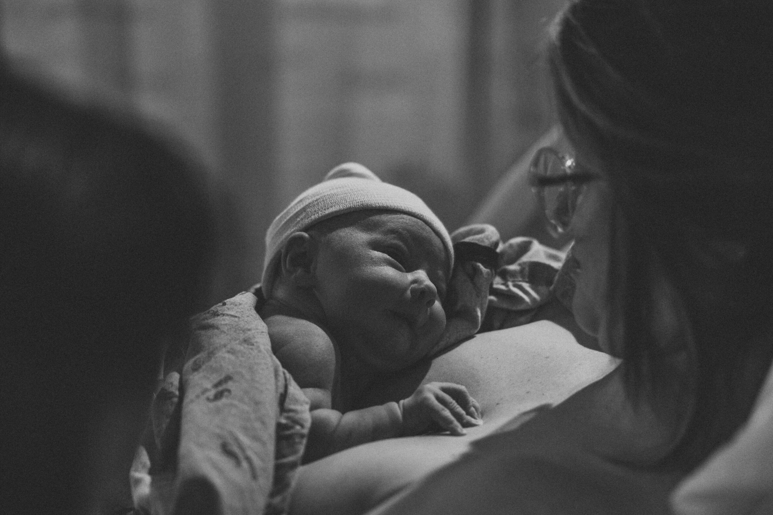Newborn girl lays on moms chest